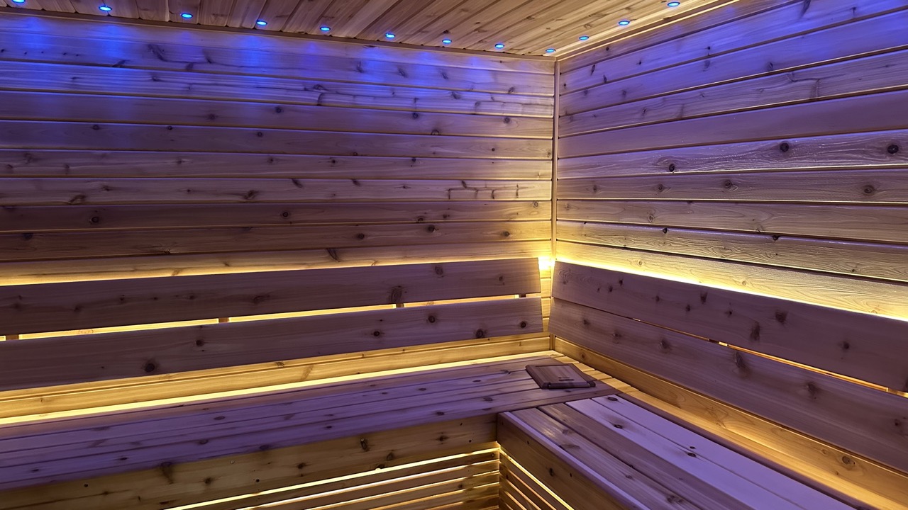 Warm cedar interior of a Bliss Mobile Sauna, illuminated for an inviting at-home spa feel.