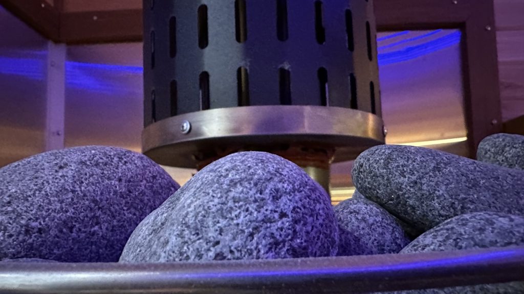 Detailed view of sauna stones, heated to perfection for consistent and soothing warmth during your session