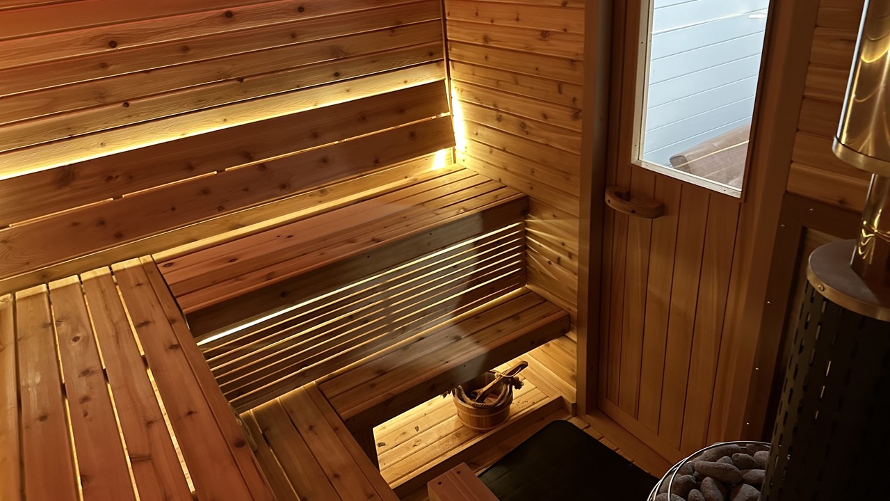 Custom cedar sauna interior by Bliss Mobile Sauna, featuring warm accent lighting, wooden benches, and a serene ambiance for ultimate relaxation