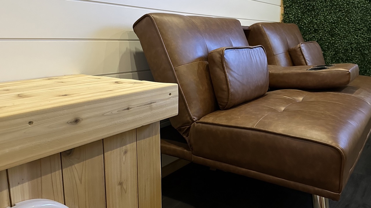 Bliss Mobile Sauna lounge area with premium leather seating and natural wood accents, creating a cozy and modern wellness retreat