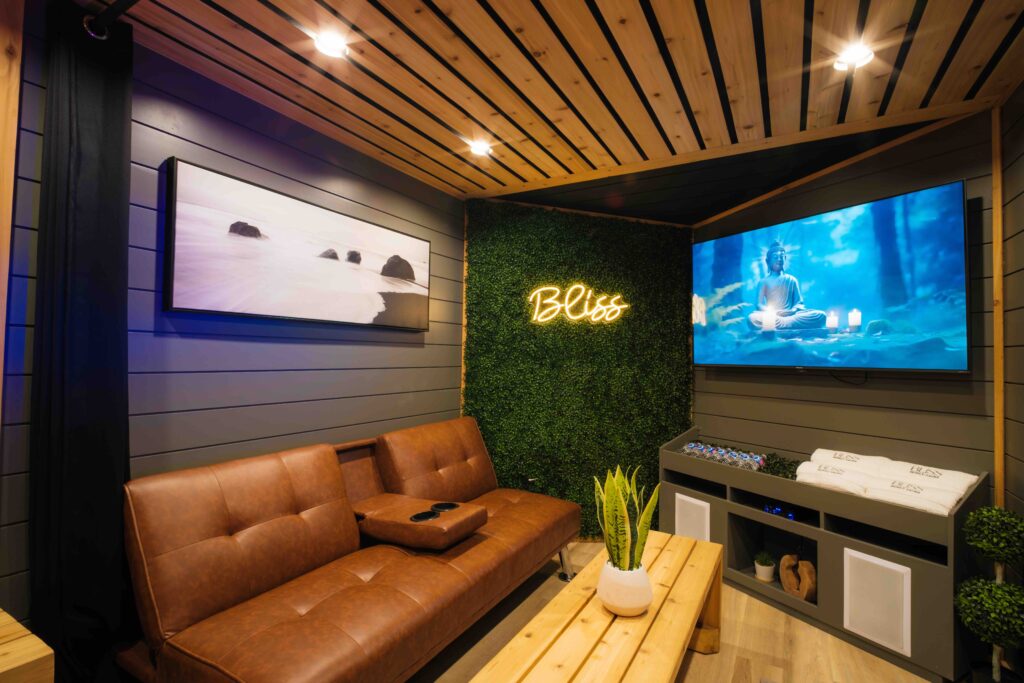 bliss mobile sauna relaxation lounge inside look into the bliss mobile sauna relaxation lounge equipped with tv, couch, decor, cedar and earth tones